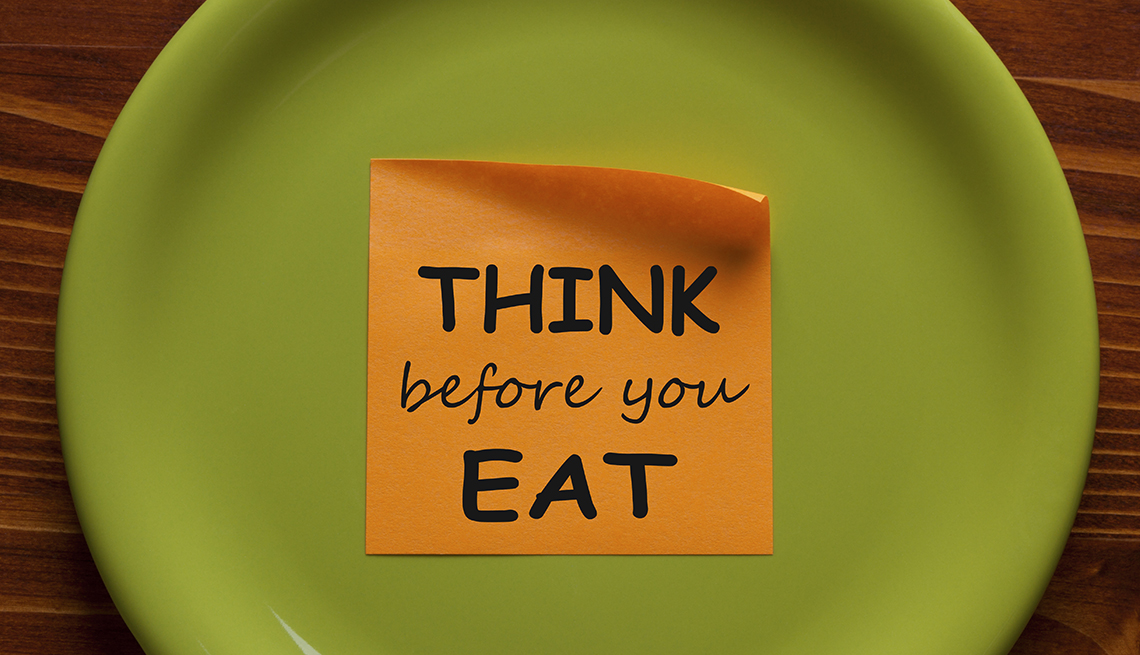 Think Before You Eat written on sticky note on a green plate.