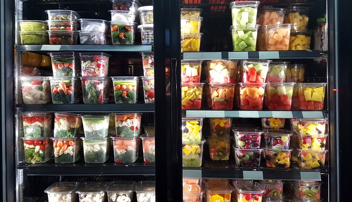 Healthy cut fruit and vegetables on display in store freezer.