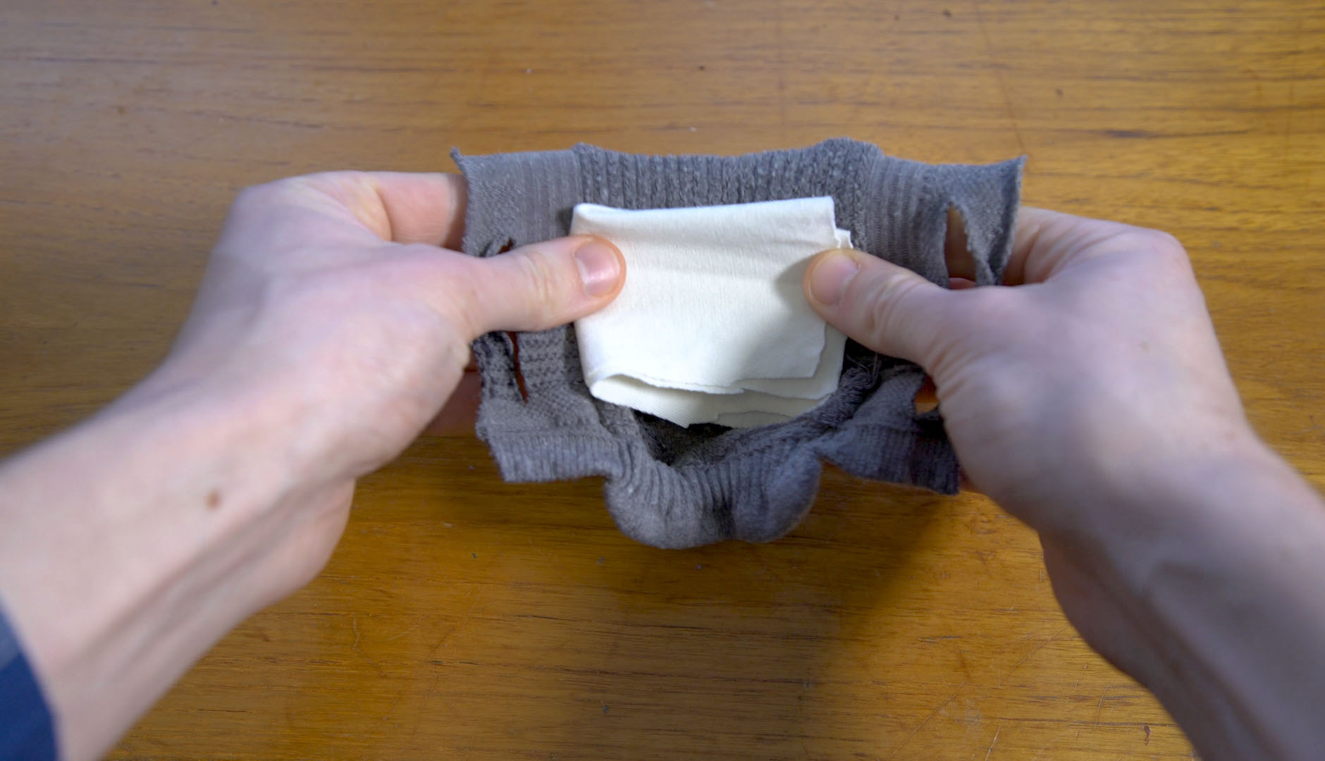 placing fabric in sock face mask