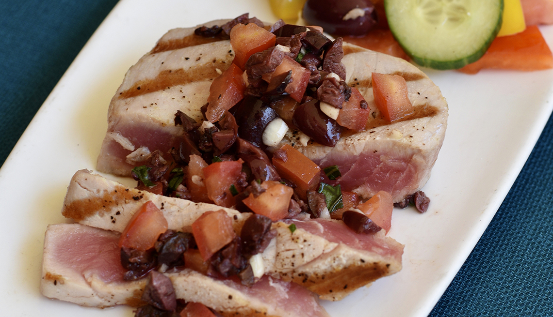 plate of grilled ahi tuna topped with tapenade
