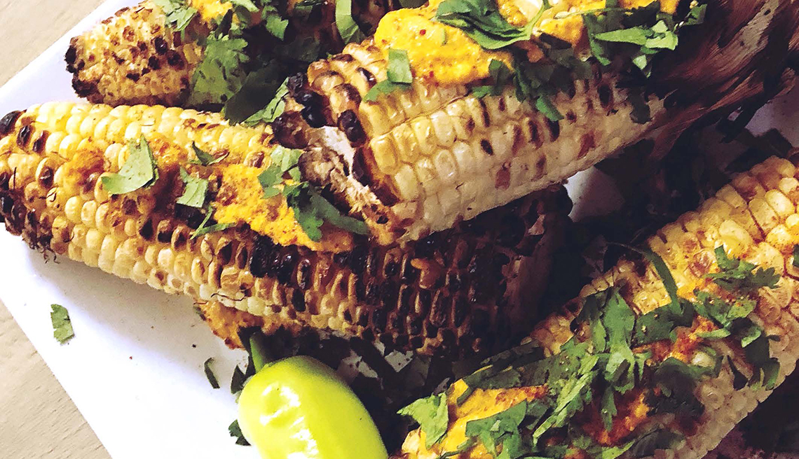 plate full of grilled corn with seasoning