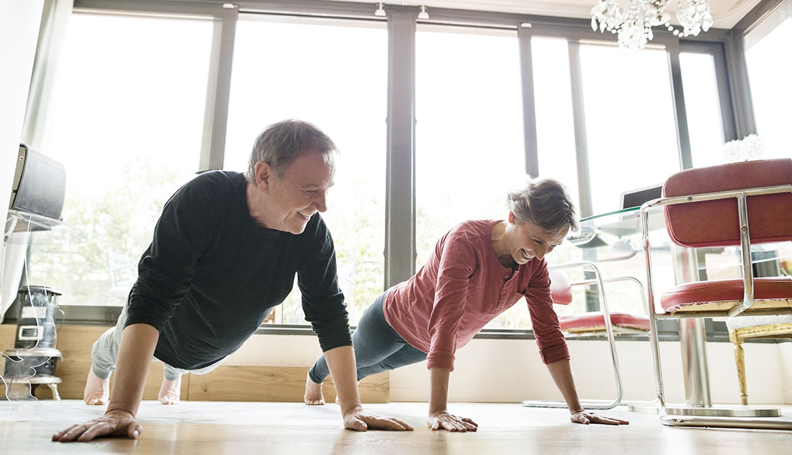 couple exercising in their dining room