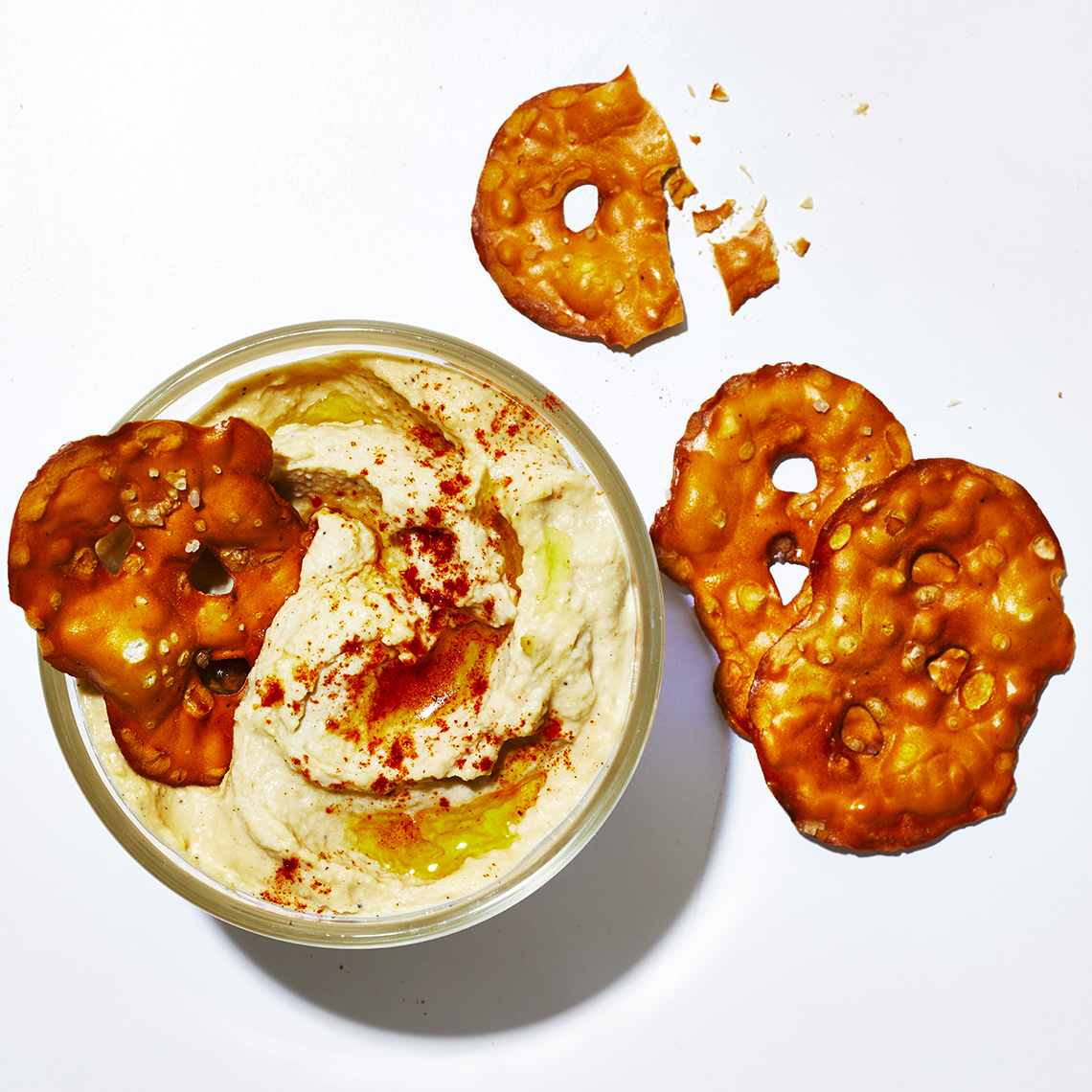 small bowl of hummus and pretzels shot from above
