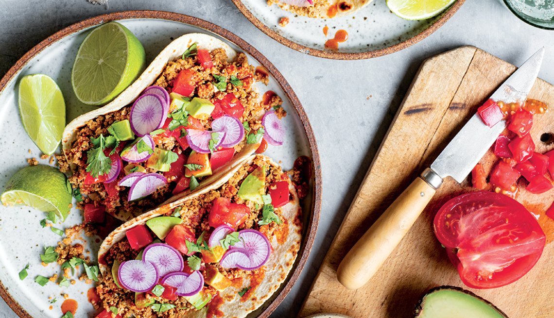 cauliflower tacos on a plate with radishes and lime