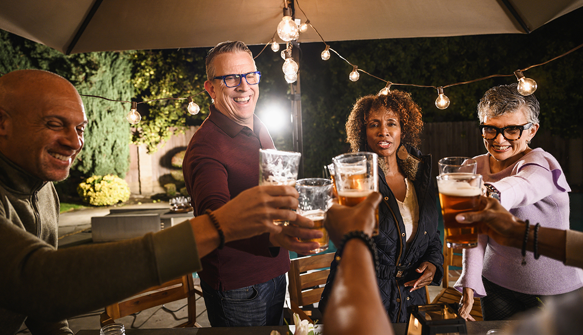 group of people giving a toast with beers