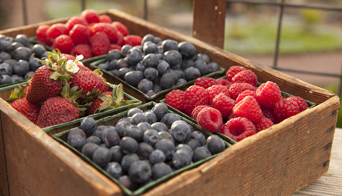 fresh berries sitting in a crate on a farm