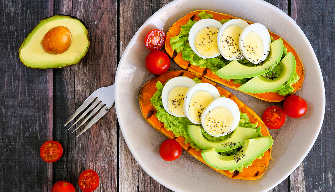Sweet potato toasts with avocado, eggs and chia seeds on a plate