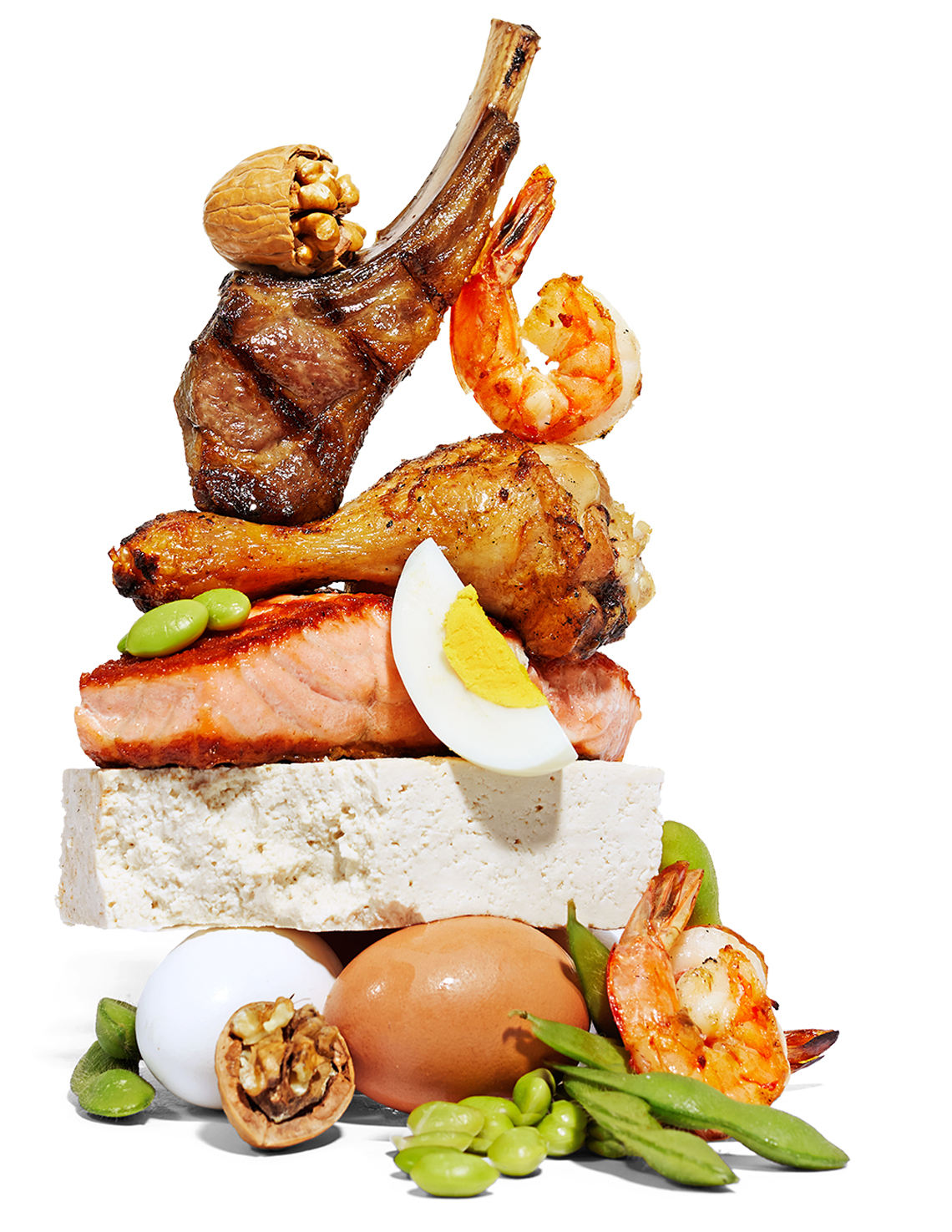 tower of healthy protein foods including eggs legumes walnuts shrimp chicken salmon lamb and tofu
