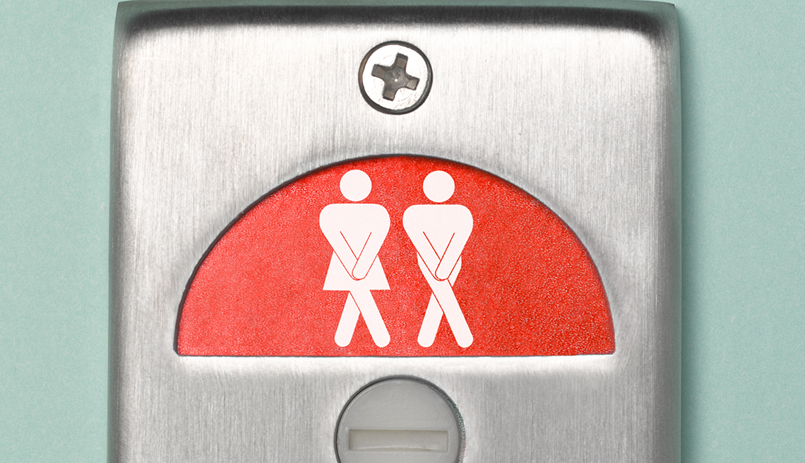 bathroom door sign showing a cartoon of a woman and a man, both looking like they have to urinate
