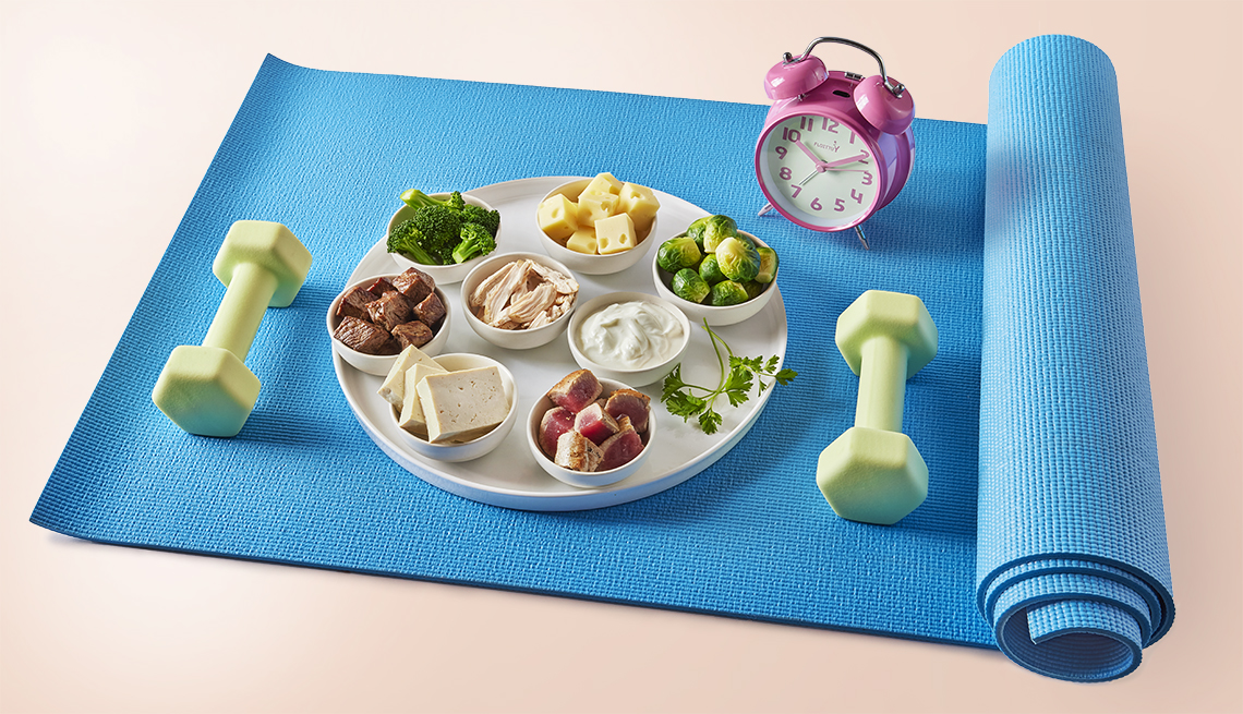 yoga mat alarm clock and hand weights along with a dish featuring servings of proteins including tofu chicken yogurt and cheese 