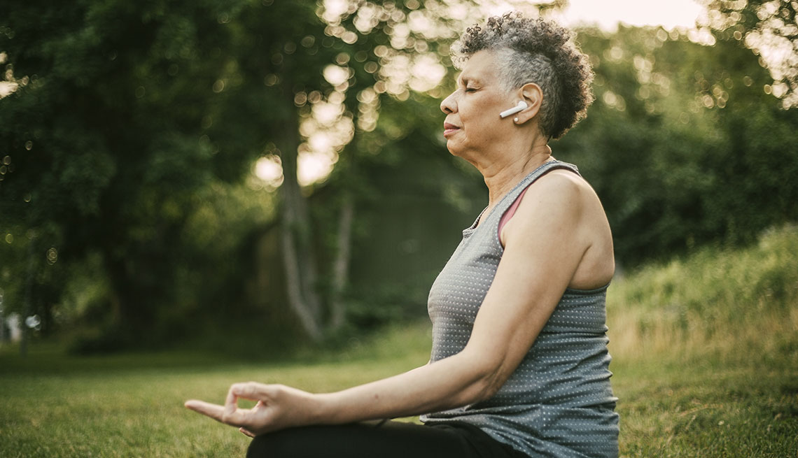 woman meditating with headphones in