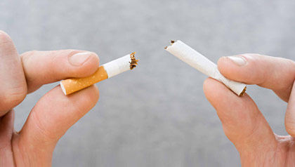 hands breaking cigarette - Medicare recipients can now access smoking cessation benefits