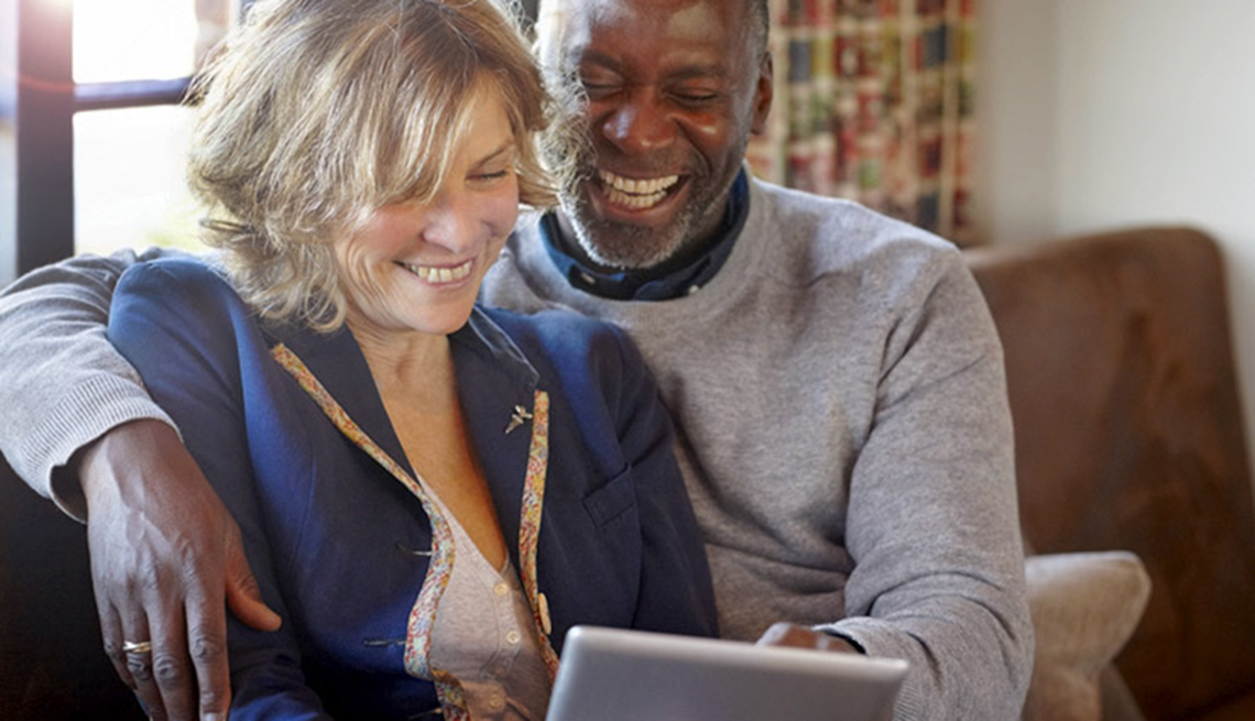 Woman and man using tablet at home, AARP's Medicare Q&A Tool 