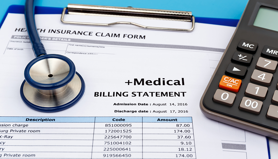 medical bill statement with a calculator and stethoscope