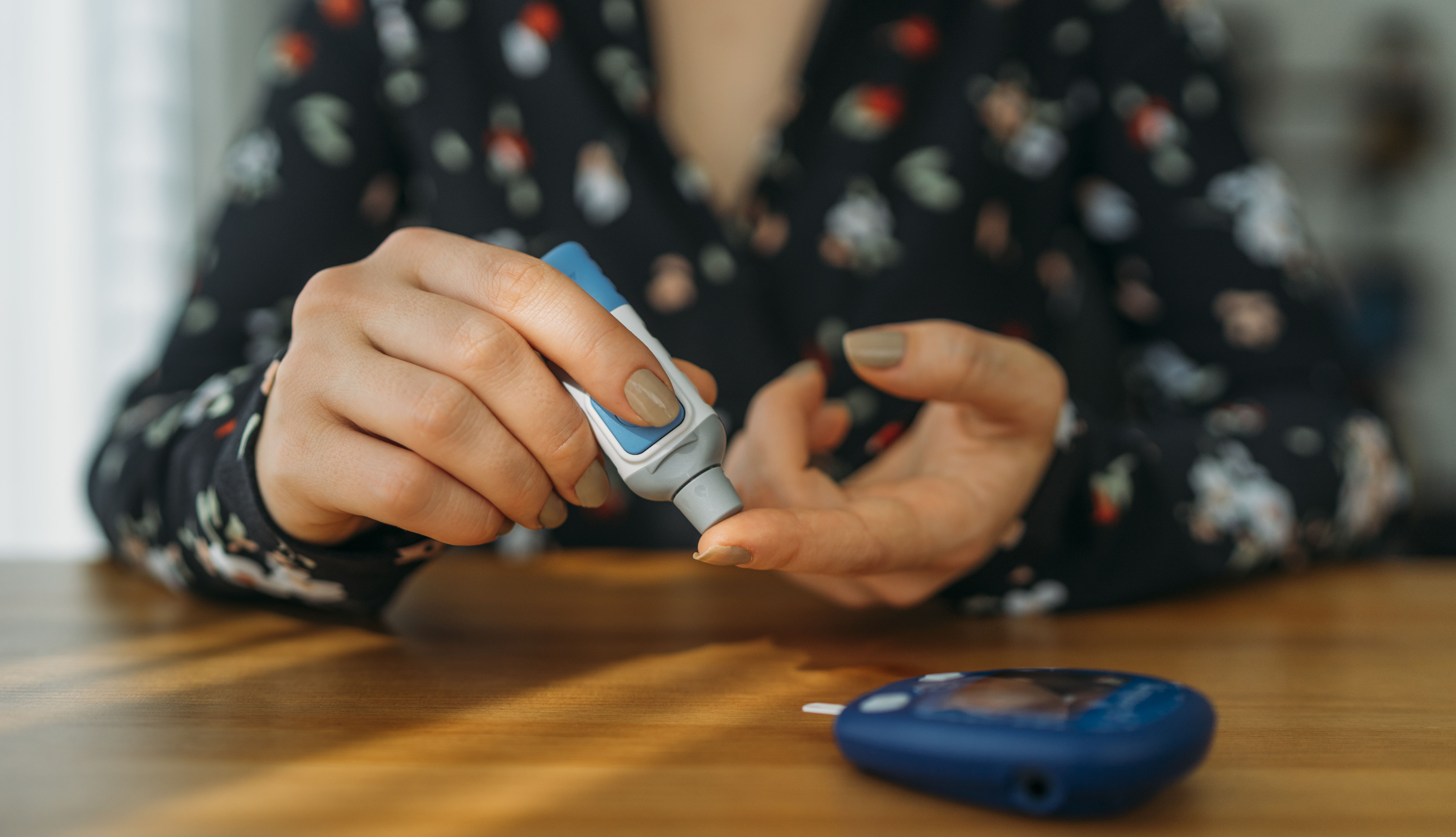 A person measuring their blood glucose