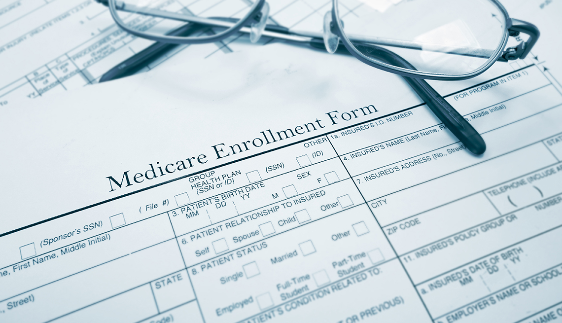 Medicare enrollment form and glasses