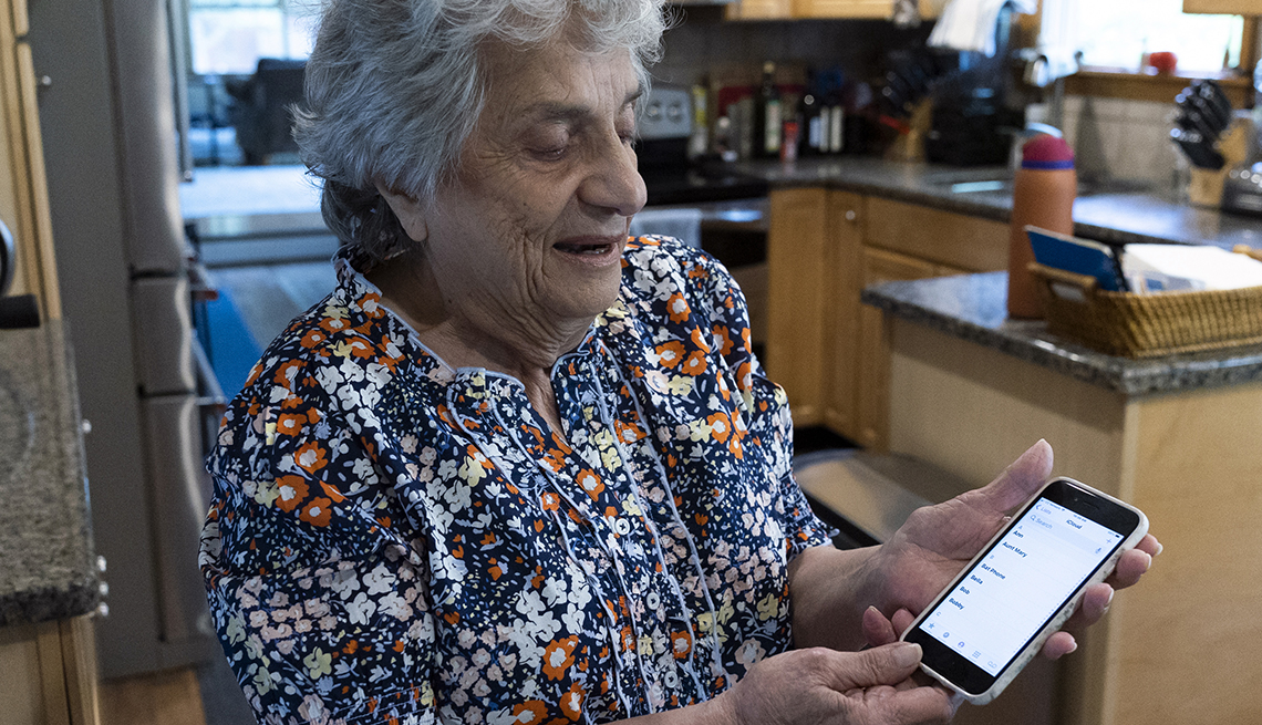 Pat Cutillo, 85, shows how she stores Dr. Meyer’s BAT phone number in her contacts at her home in Downingtown, Pennsylvania on May 29, 2023. 