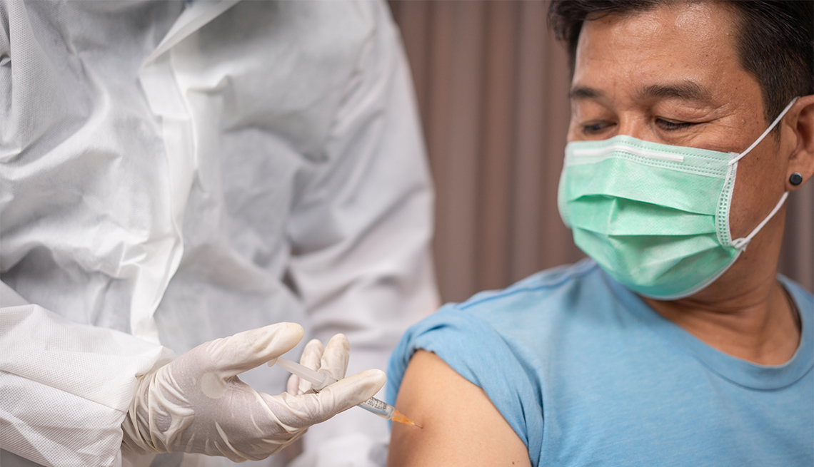 Male patient getting vaccinated at medical clinic during coronavirus pandemic.