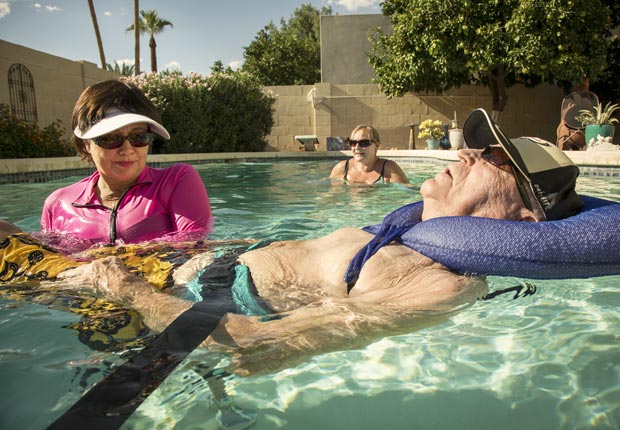 Amy Goyer, her father and physical therapist Donna in the pool, Juggling Work and Caregiving (Beth Perkins Photography)