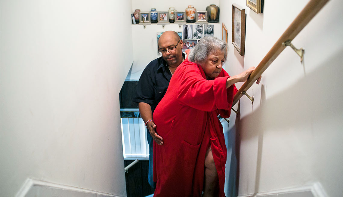 A Day in the Life of a Caregiver, Marcus Butler helps his mother Melida up the stairs