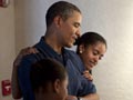 Barack Obama and daughters Sasha and Malia at an exhibit in Honolulu, Hawaii
