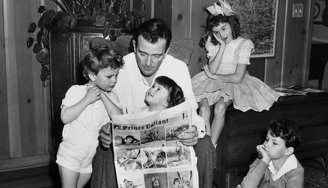 John Wayne reading to four of his children