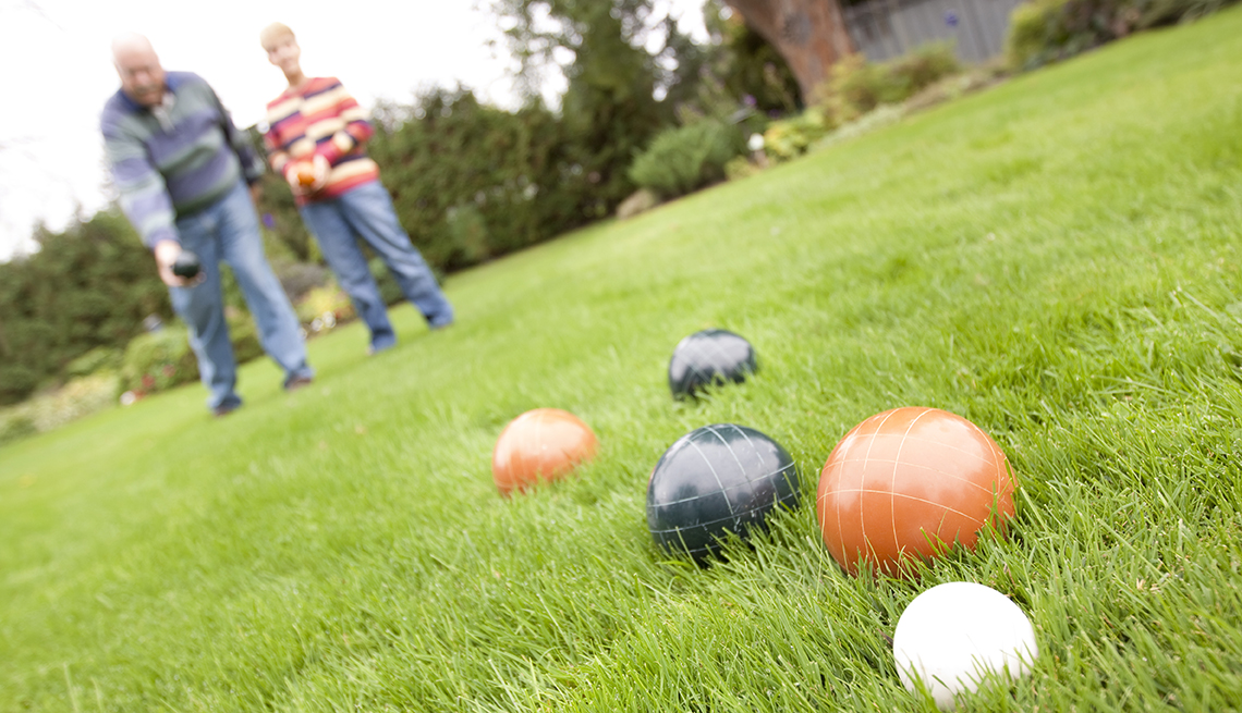 item 5 of Gallery image - older man and younger person playing bocce or lawn bowling 