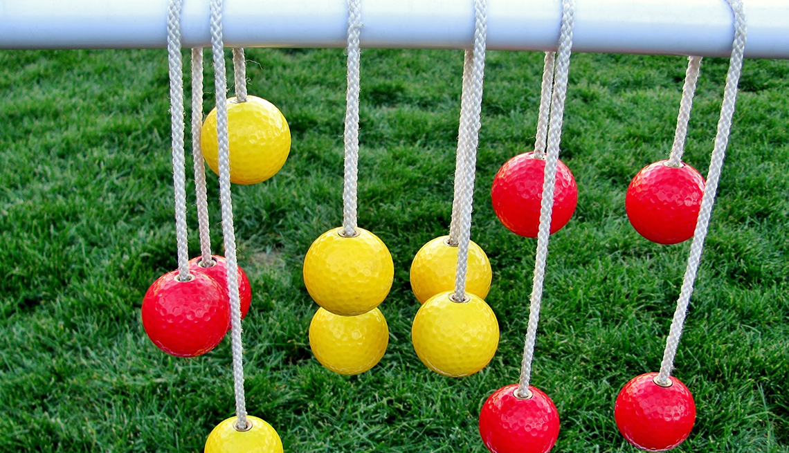 item 3 of Gallery image - Yellow and red balls hanging on ladder toss ladder in front of a green lawn