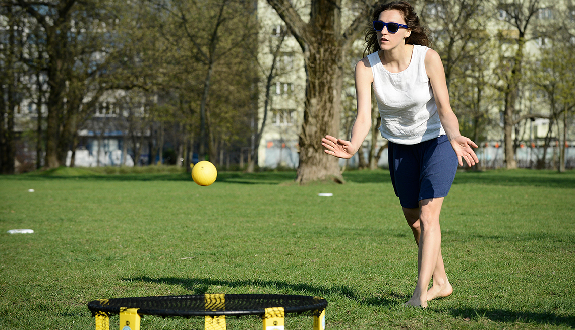 item 7 of Gallery image - woman playing spikeball in a park