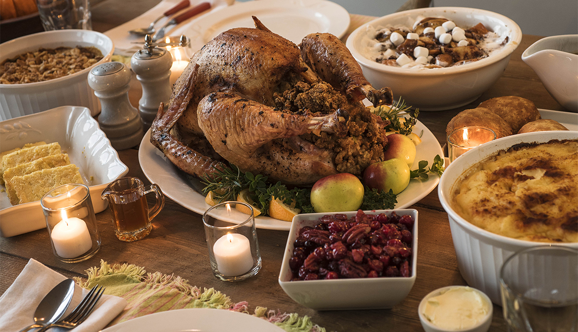 table set for Thanksgiving dinner with turkey, cornbread and more