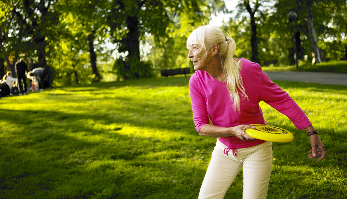 item 9 of Gallery image - woman about to throw a frisbee outdoors on a lawn