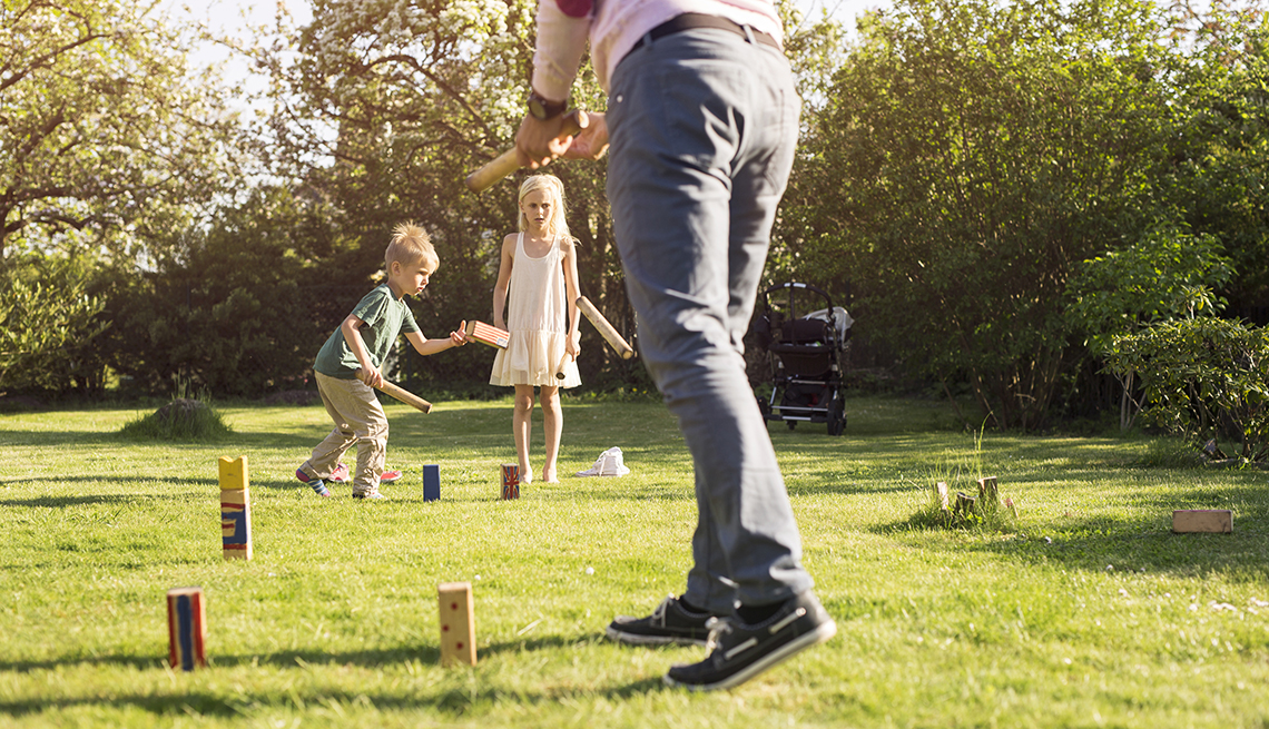 item 8 of Gallery image - two small children and a man in a yard playing the lawn game kubb