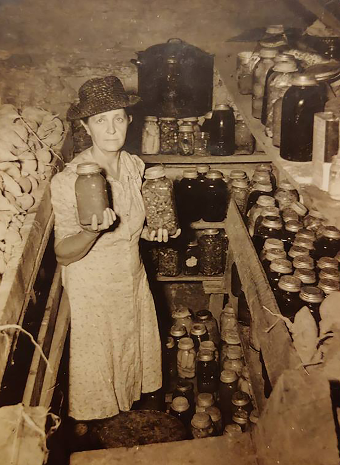 sepia photo of a woman in her canning cellar