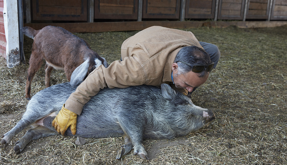 item 4 of Gallery image - Christian Sariol with pet pig Abby. 