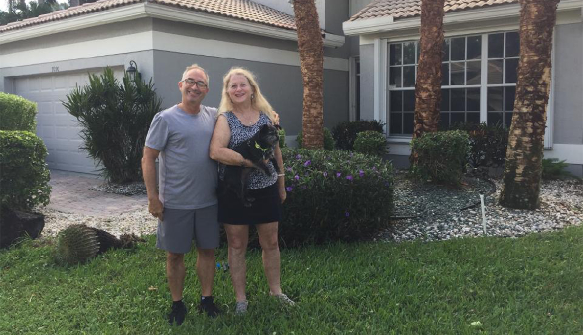 David and Ellen Comisar(holding their dog Kiwi) in front of their new Delray Beach home.