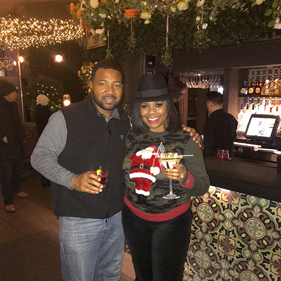 schwanda vickers wearing a christmas sweater with one of her family members