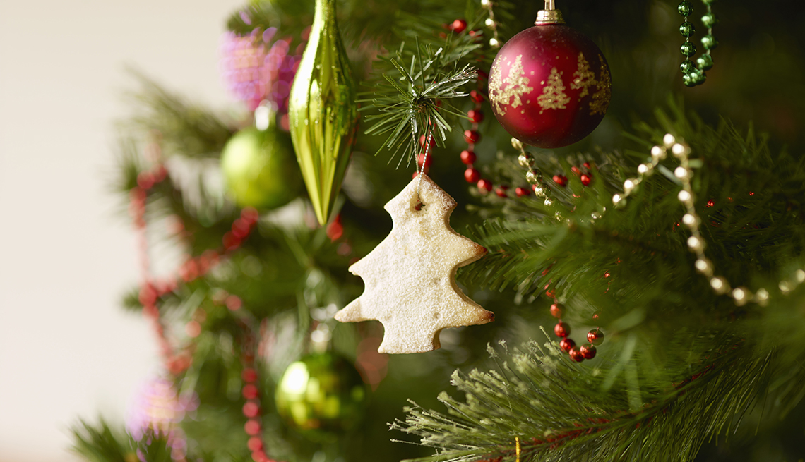 closeup of a tree shaped cookie decoration hanging on a christmas tree
