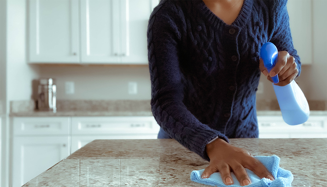 Close-up of woman cleaning kitchen counter