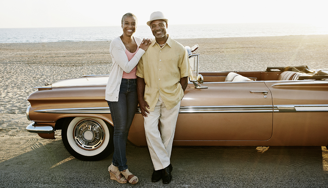 Couple with convertible on the beach, Pros and Cons of buying convertibles