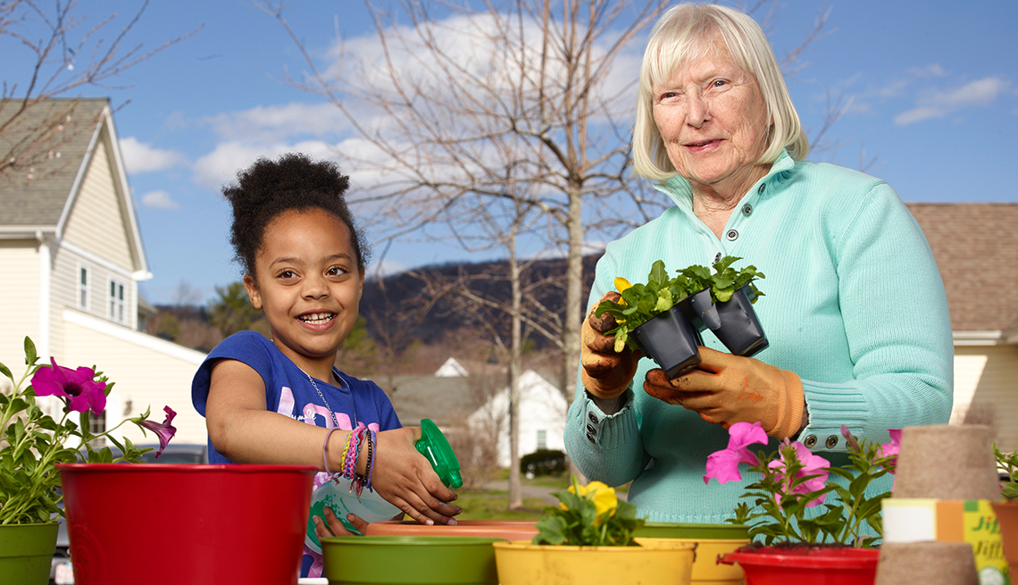 Mary Steele, right, plant flowers with a foster child at Treehouse Community in Massachusetts. 