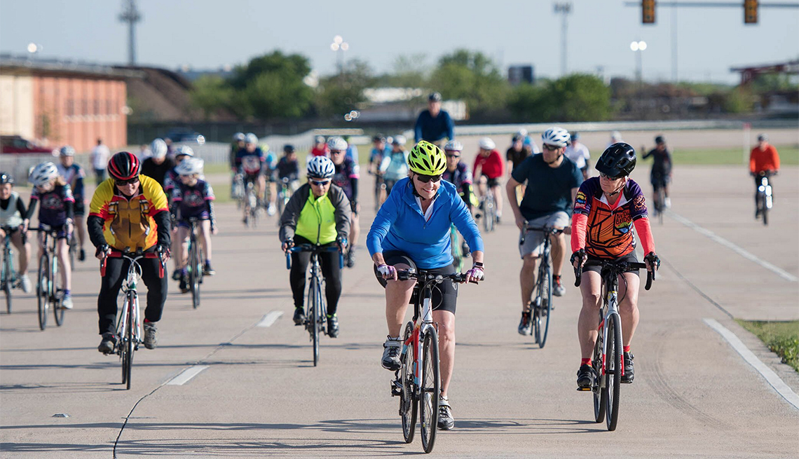 A large group of bicyclists riding on a road