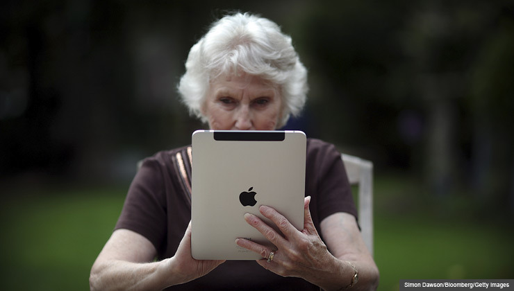 How to pass your digital information- photos, text messages, and e-mails- down to your heirs- a senior woman uses her iPad