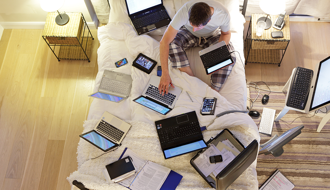 Anonymous man in white shirt holding tablet in front of face being