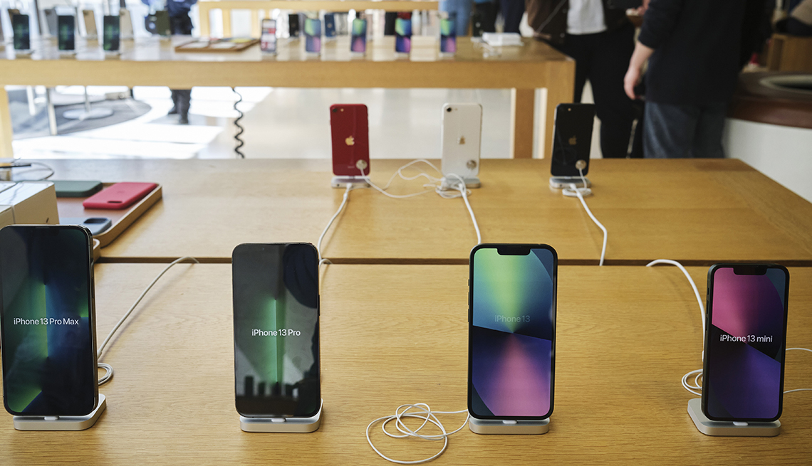 new iphone 13 devices on display on a wooden table
