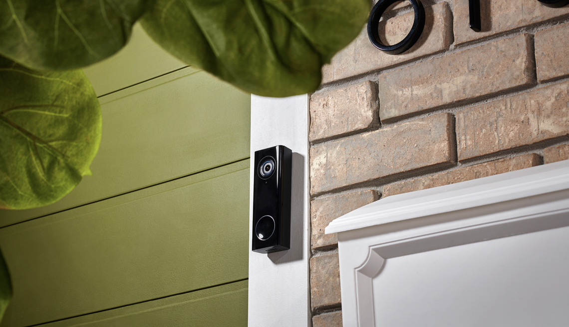 a smart doorbell at the front door of a house