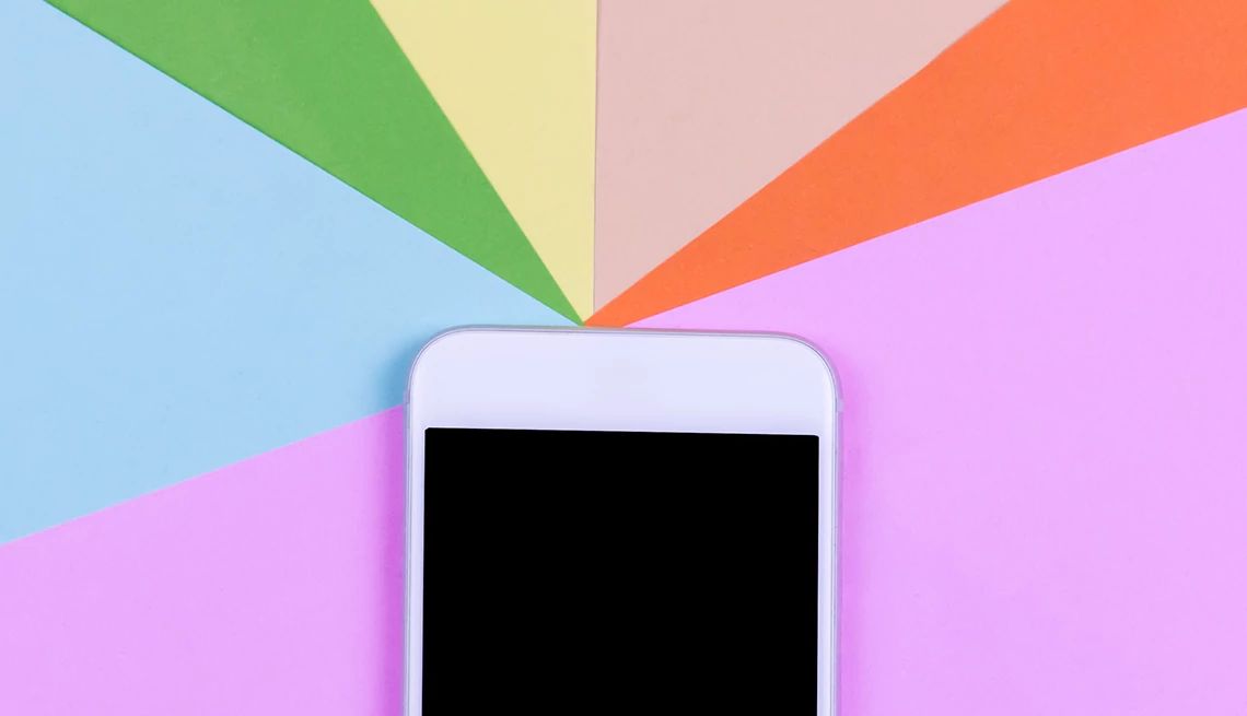 A smartphone with a rainbow on the top of it