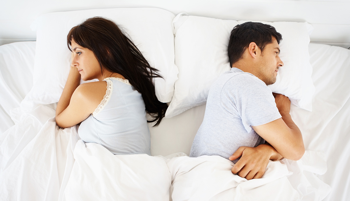 Angry Couple Facing Away From Each Other In Bed, AARP Home And Family, Sex And Intimacy, Relationships, Destructive Relationship Myths