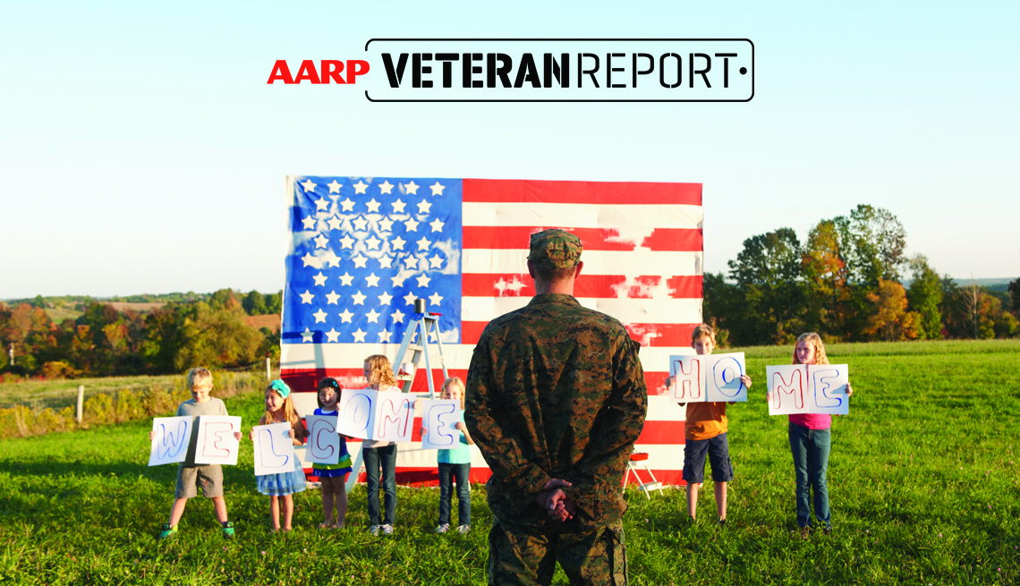 people hold up a welcome home sign as someone from the military stands before an american flag. the words aarp veteran report appear above the flag