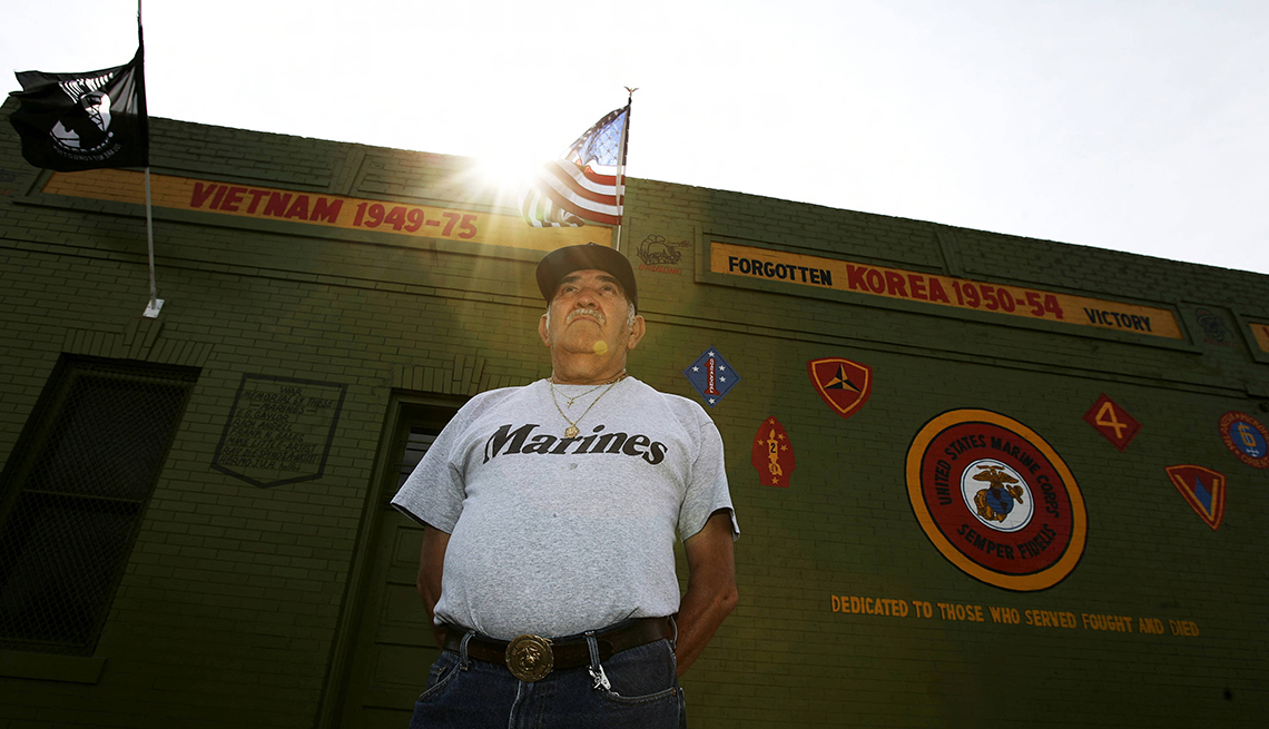 Prominent Denver artist and former Marine Ray Espinoza, cq, stands in front of a mural at E 47th Ave. and Baldwin Ct. in Denver, Friday June 30, 2006, he painted and dedicated to those Marine Corps. members who have served and fallen in war.