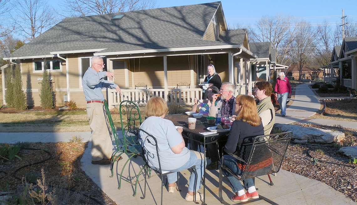 Residents of Oakcreek Community meet outdoors on a sunny day